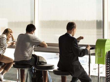 Passengers sitting by the window at Helsinki Airport