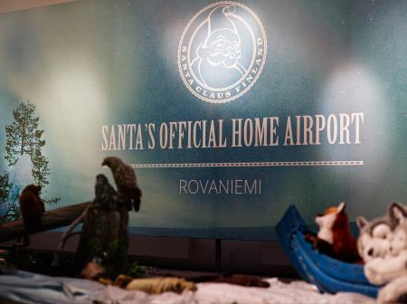 Some stuffed animals and wall decal that says "Santa's official home airport, Rovaniemi".
