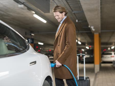 Men charging an electric car