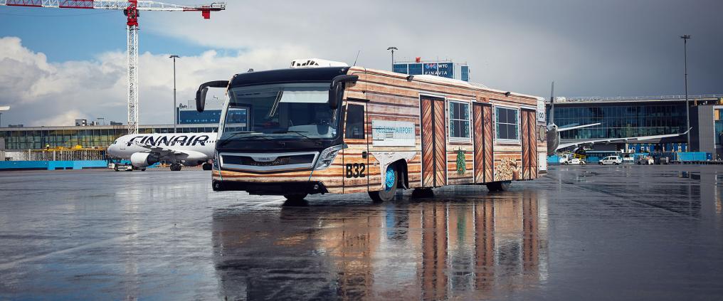 An airport buss painted to look as made out of wood.
